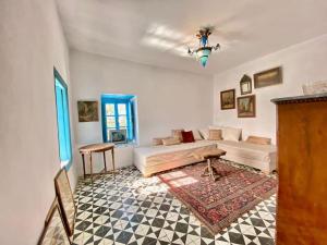 a living room with a couch and a table at Lella Khadija B&B Sidi bou said in Tunis