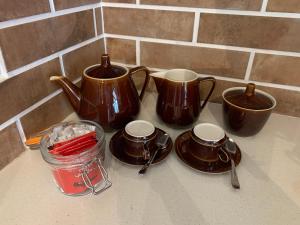 a group of cups and saucers on a counter at Villa Kamaya, Chamarel in Chamarel