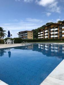 a large swimming pool in front of a building at Gavoa Resort - 2 quartos - BL D apt 209 in Igarassu