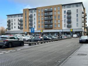 a parking lot with cars parked in front of buildings at Stunning Cozy Flat 2. in Belvedere