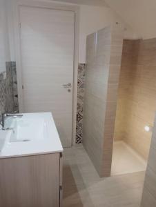 a white bathroom with a sink and a shower at L'alloggio delle vacanze estive in Corsano +36 photos