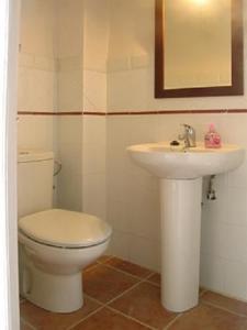 a bathroom with a white toilet and a sink at Ca la tieta Quima in Guiamets