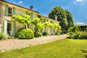 an old house with a garden in front of it at Belle maison de charme in Lussac