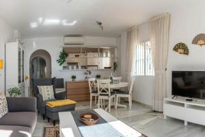 a living room with a couch and a table at Golf/Seaview 2 bedroom apartment in Sitio de Calahonda - Mijas in Mijas