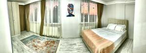 a bedroom with a bed in a room with windows at Airport forest villa hotel in Arnavutköy