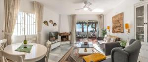 a living room with a couch and a table at Golf/Seaview 2 bedroom apartment in Sitio de Calahonda - Mijas in Mijas