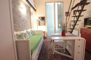 a living room with a green couch and a table at Amenano Apartments in Catania