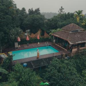 an overhead view of a swimming pool at a resort at Khao Sok Boutique Camping - Exotic Cliff Camping in Ban Bang Thong