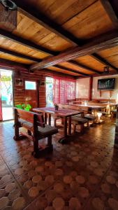 a room with tables and benches in a building at Guesthouse Madzarevic in Pluzine