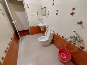 a bathroom with a toilet and a sink at Marari Beach Homestay in Mararikulam