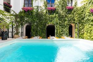 a swimming pool in a building with plants at Casa Nostra Luxury Suites & Spa in Palermo
