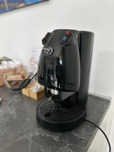 a black coffee maker sitting on top of a counter at Lotelito Apartment in Fisciano