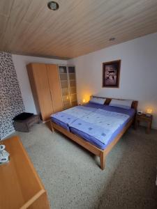 a bedroom with a bed with a blue comforter at Schnuckelige Wohnung in Marl
