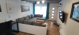 a living room with a couch and a tv at Protea Inn Ferienwohnungen in Bad Nauheim