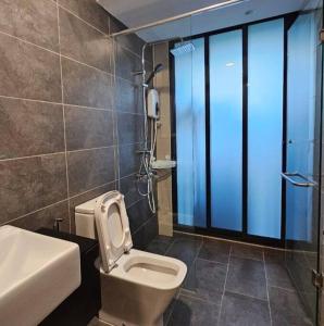 a bathroom with a toilet and a sink at Almas Suite @ Puteri Habour, Iskandar Puteri, Johor in Nusajaya