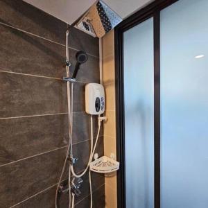 a shower with a blow dryer in a bathroom at Almas Suite @ Puteri Habour, Iskandar Puteri, Johor in Nusajaya