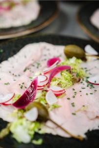 a plate of food with meat and vegetables on it at Hotel Steineweiher in Saint-Vith