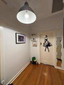 a room with a door with a drawing of a woman on it at Clarence Gardens in Colonel Light Gardens