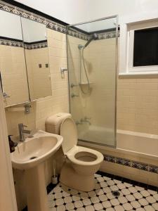 a bathroom with a toilet and a sink and a shower at Clarence Gardens in Colonel Light Gardens