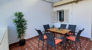 a patio with a wooden table and chairs at Magdalena Plaza City Center 2 in Seville