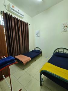 Ένα ή περισσότερα κρεβάτια σε δωμάτιο στο Homestay Uni, Kuala Kedah