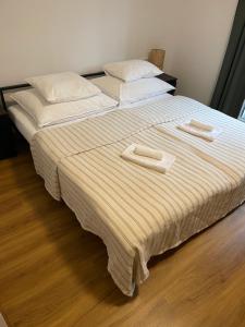 two beds in a bedroom with two towels on them at Apartment Hilde in Schwaz
