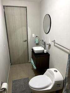 a bathroom with a toilet and a sink and a mirror at Workation Montpellier in Santa María Coronanco