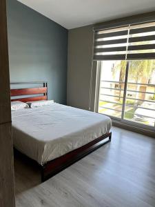 a bedroom with a bed and a large window at Workation Montpellier in Santa María Coronanco