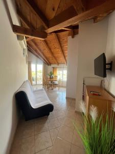 a living room with a couch and a tv at Villa Sunce in Jezera