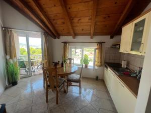 a kitchen and dining room with a table and chairs at Villa Sunce in Jezera