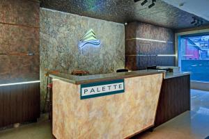 a lobby with a table with a sign on it at Palette - Madhapur in Hyderabad