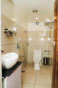 a white bathroom with a sink and a toilet at Accom Hotel in Ilām +23 photos