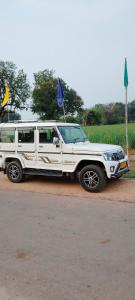 a white truck parked on the side of a road at Laxmi home stay in Ghūra