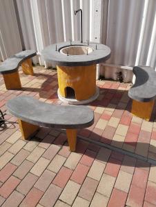 three benches with a sink in the middle of a room at Sarkcsillag teljes családiház- Star Complete Family House in Szeged