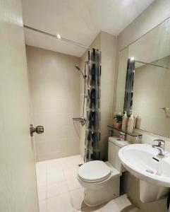 a bathroom with a toilet and a sink at Azure Urban Resort Residences Paranaque 2 Bedroom Unit in Manila