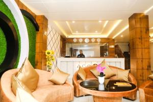 a living room with a couch and a table at Accom Hotel in Ilām