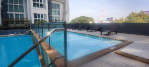a swimming pool on top of a building at The Prio Condo in Chiang Mai