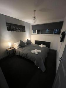 a bedroom with a bed with two towels on it at Washington Residence in Usworth