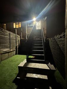 a set of stairs in a stadium with a light at Nice & Cozy Furnished 1 Bedroom Flat in Luton
