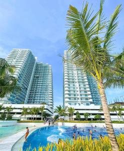 a resort swimming pool with two tall buildings at Condo At Azure North San Fernado in San Fernando