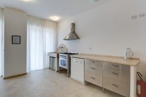 a kitchen with a sink and a stove top oven at Guesthouse Vassallo Uno in Rome