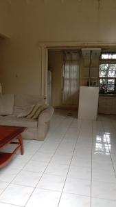 a living room with a couch and a table at Villa Kota Bunga Puncak Bogor in Cimacan