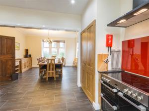 a kitchen with a table and a dining room at 5 Bed in Brodick CA016 in Brodick