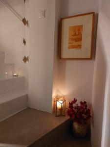 a hallway with a vase of flowers and a light at La Niña de Vejer in Vejer de la Frontera +19 photos