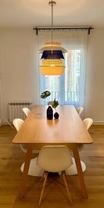 a dining room table with a potted plant on it at Plaza Tomás in Pamplona