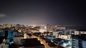 a view of a city at night with buildings at San Gabriel un habitacion Torremolinos in Torremolinos