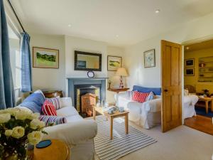ein Wohnzimmer mit 2 weißen Sofas und einem Kamin in der Unterkunft 3 Bed in Sedgeford 90011 in Sedgeford
