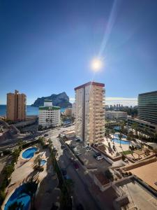 an aerial view of a city with buildings and the ocean at Esmeralda Suites Calpe in Calpe