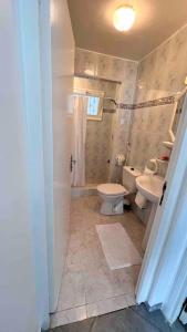 a bathroom with a toilet and a sink at Maison avec jardin à 2 minutes à pied de la plage in Temara