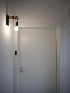 a white door with a light on top of it at Loft Schottenau in Neusiedl am See